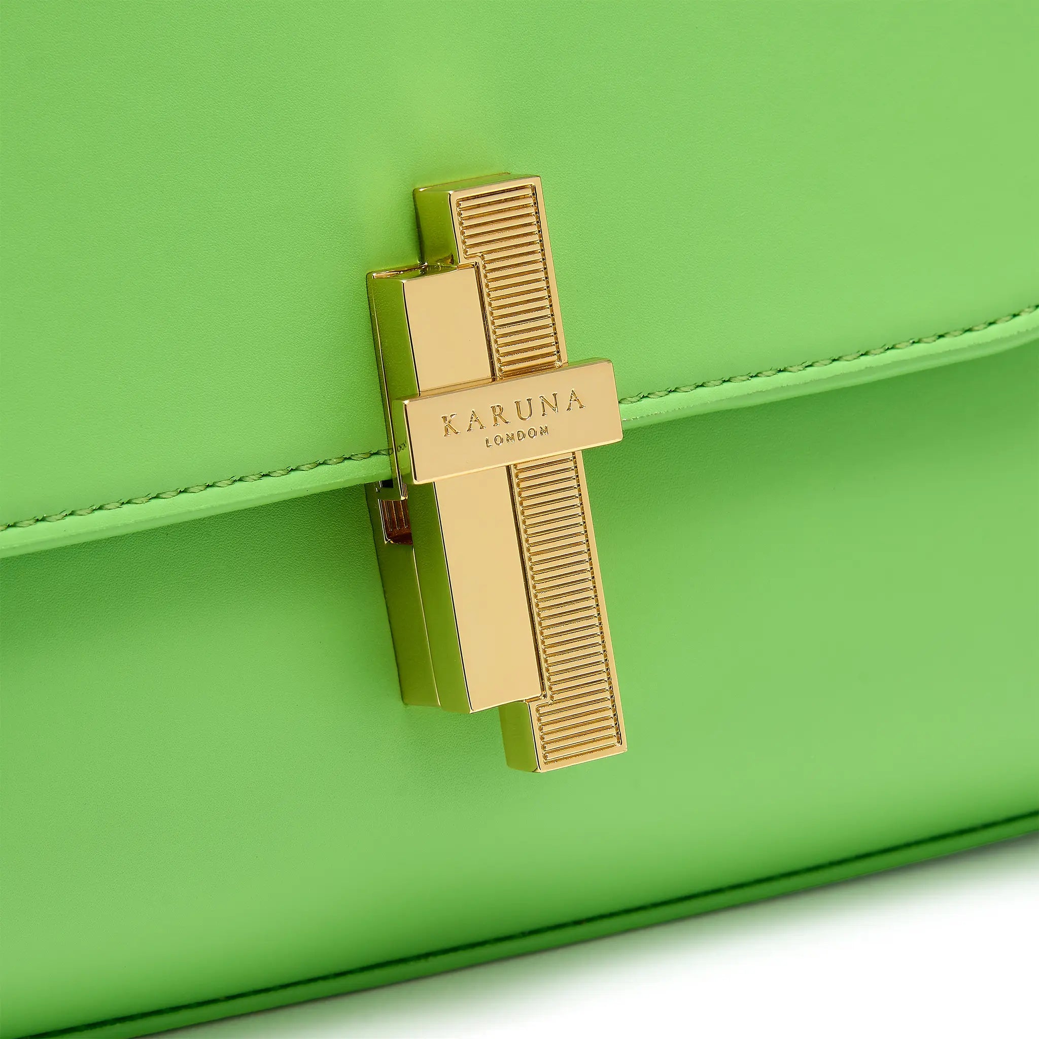 Karuna London Maddox apple green top handle bag with branded lock