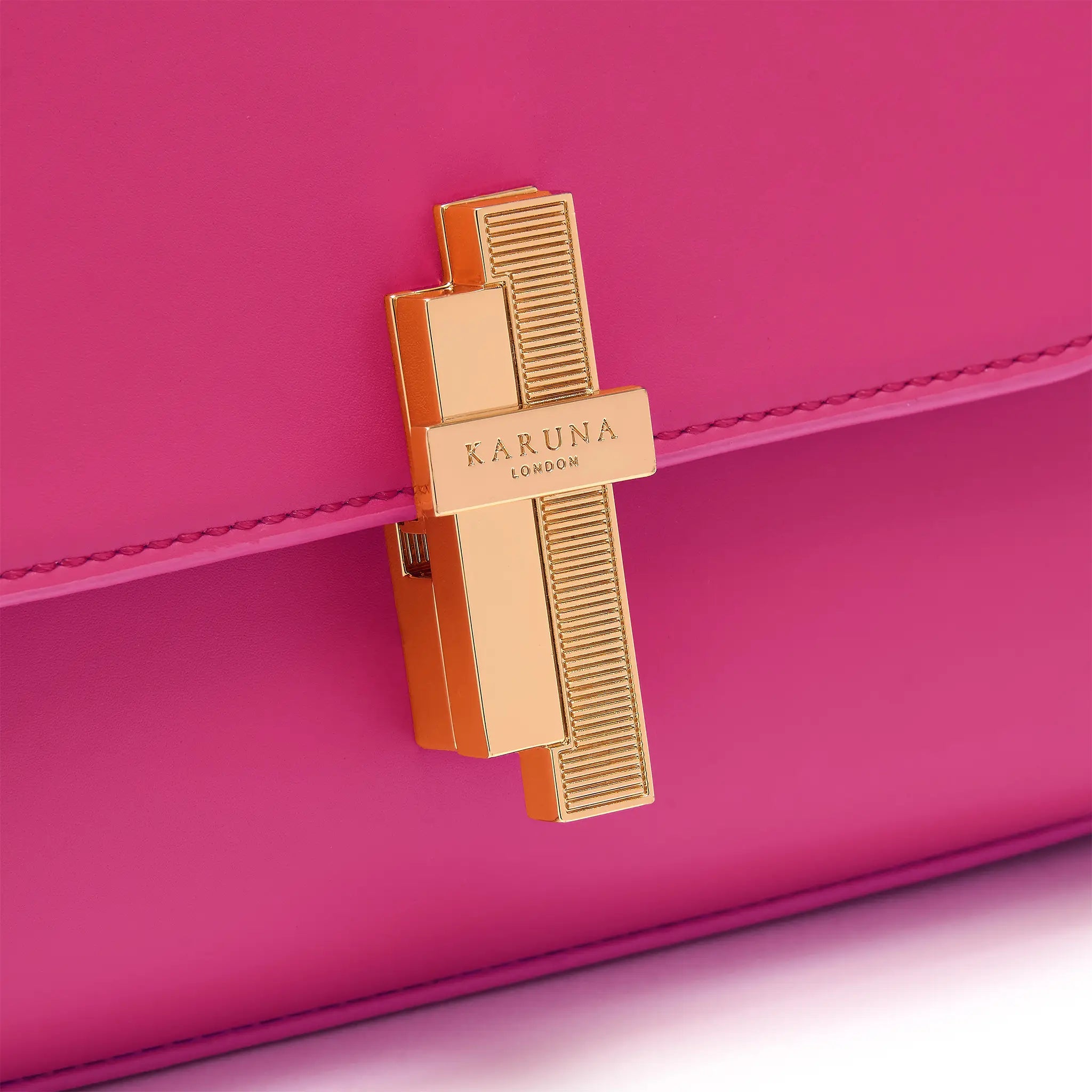 Karuna London Maddox magenta top handle bag with branded lock