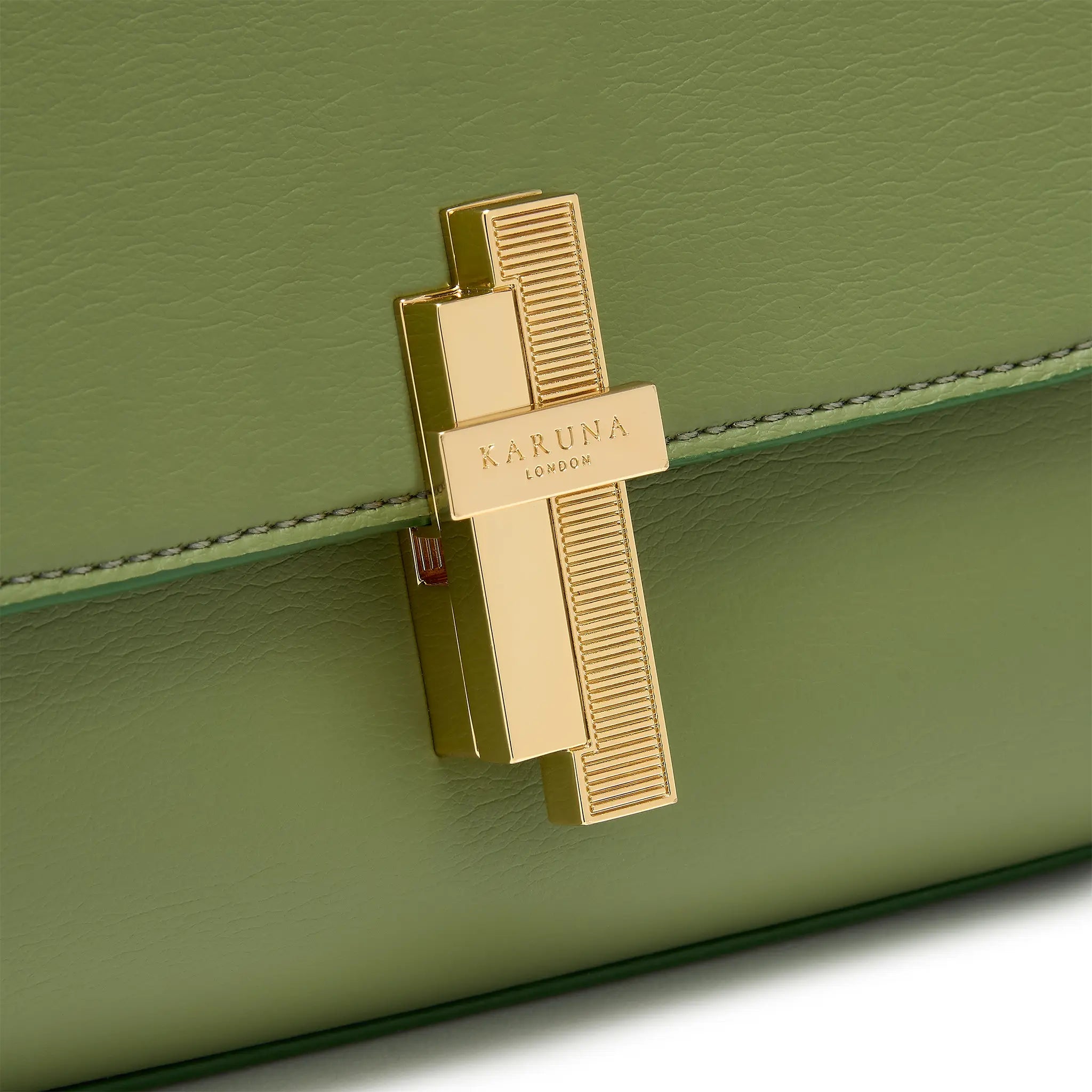 Karuna London Maddox olive green top handle bag with branded lock