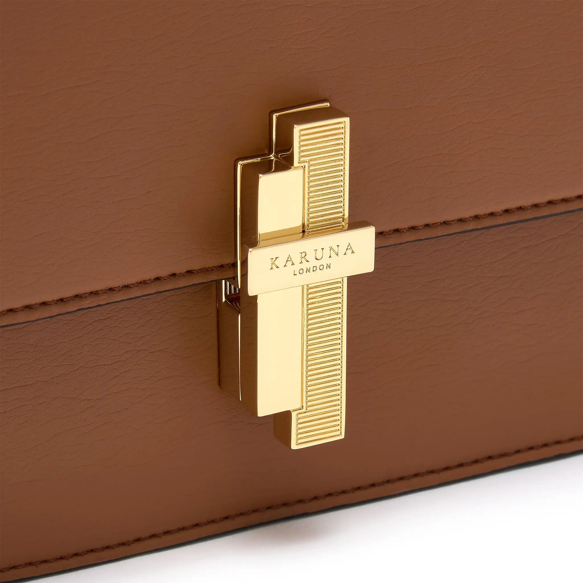 Karuna London Melrose cinnamon cross body bag with branded lock